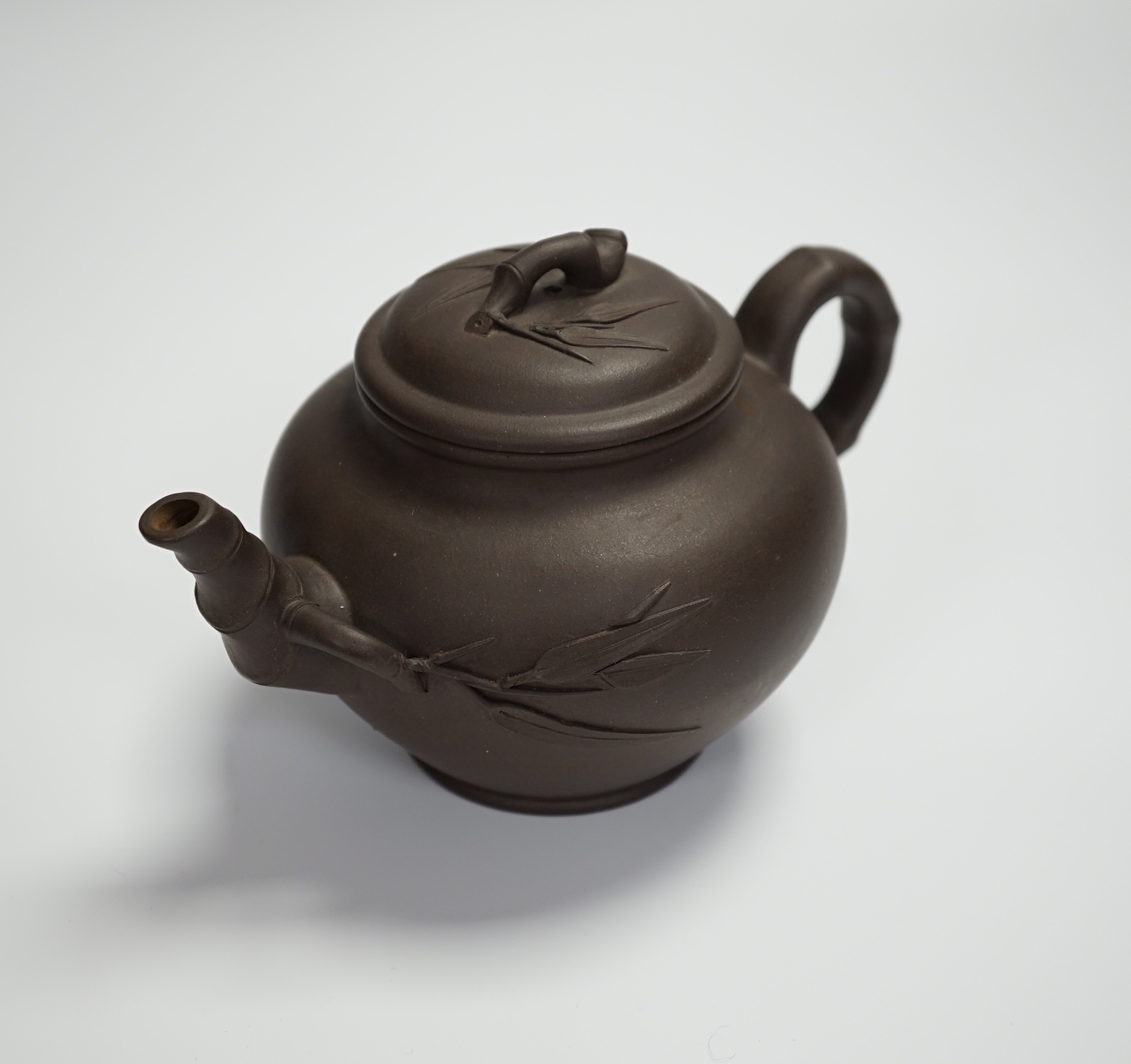 A mid 20th century Chinese Yixing teapot, signed, with bamboo design, 11cm high